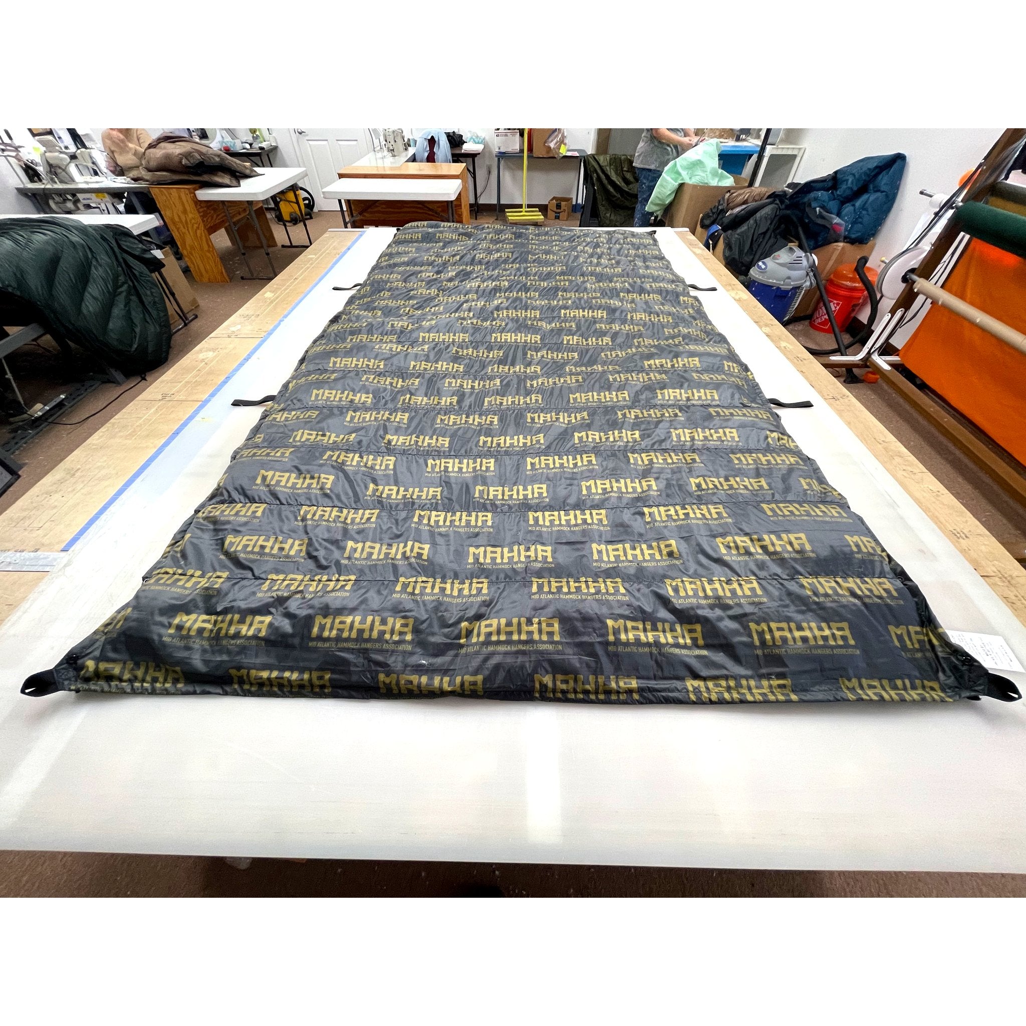 Custom ultralight backpacking quilt in the MAHHA limited edition print, dark grey with yellow lettering