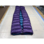 Custom ultralight backpacking quilt with a Purple shell and Moroccan Blue lining, formed into a foot box and laid full length on the workshop table