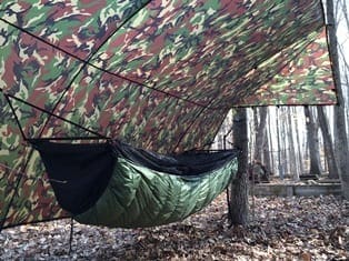 Jacks R Better Bear Mountain Bridge Hammock set up between two trees at a campsite