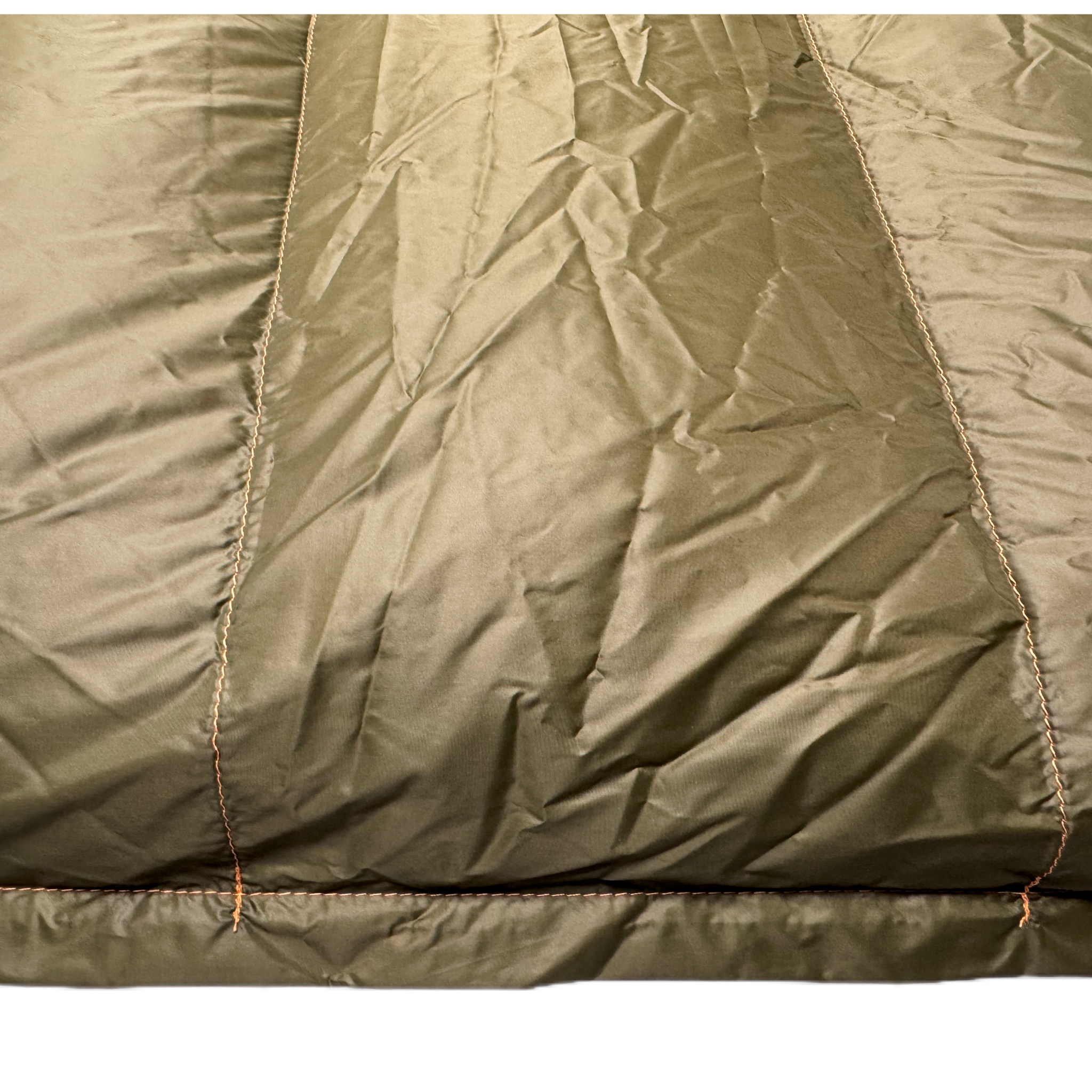 Close-up detail of Jacks R Better Hudson River 20 degree camping quilt showing olive taffeta shell fabric and baffle construction