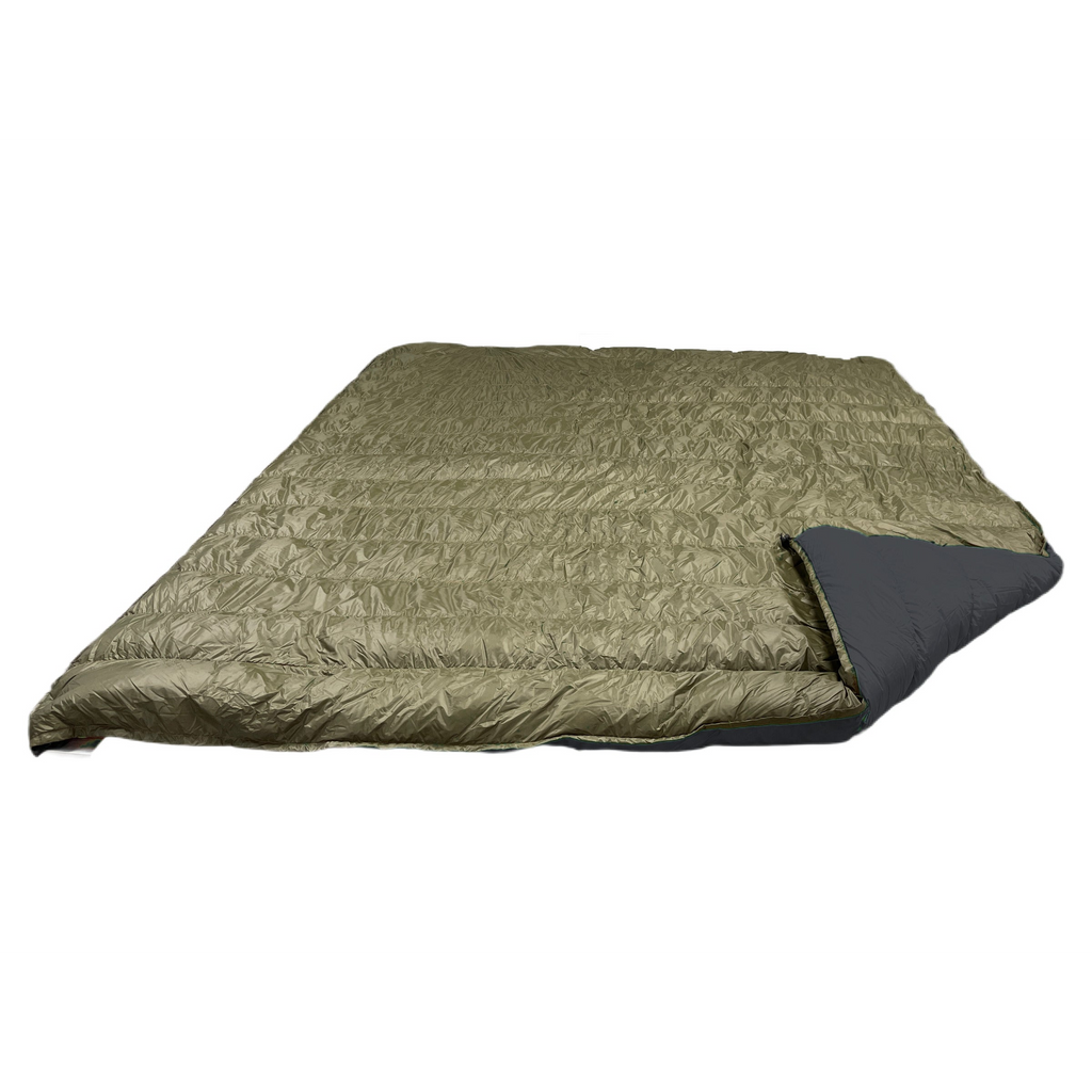 Jacks R Better Overland 20°F overlanding and RV camping quilt laid flat, dark olive shell with the corner turned back to show the black lining