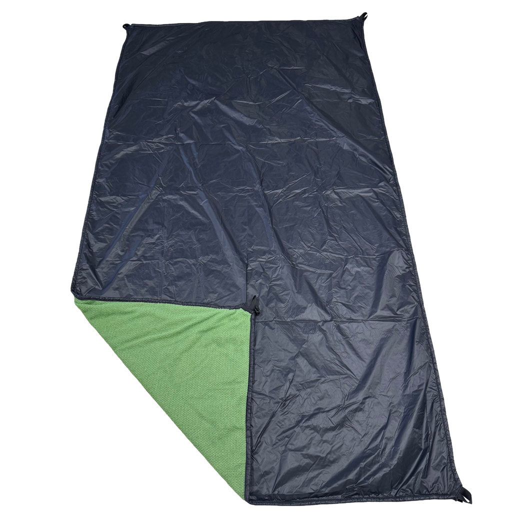 Jacks R Better Wind Gap Alpha multifunction wind liner Ion shell side with the corner folded back revealing the Fern Green Alpha Direct layer