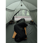 Black Polartec Alpha Direct Quilt Liner used as a stand alone blanket on a camping mat inside a tent — ultralight backpacking sleep system