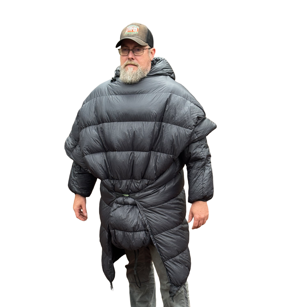 Man wearing the Sierra Stealth 40° wide wearable down quilt as a wrap, front view